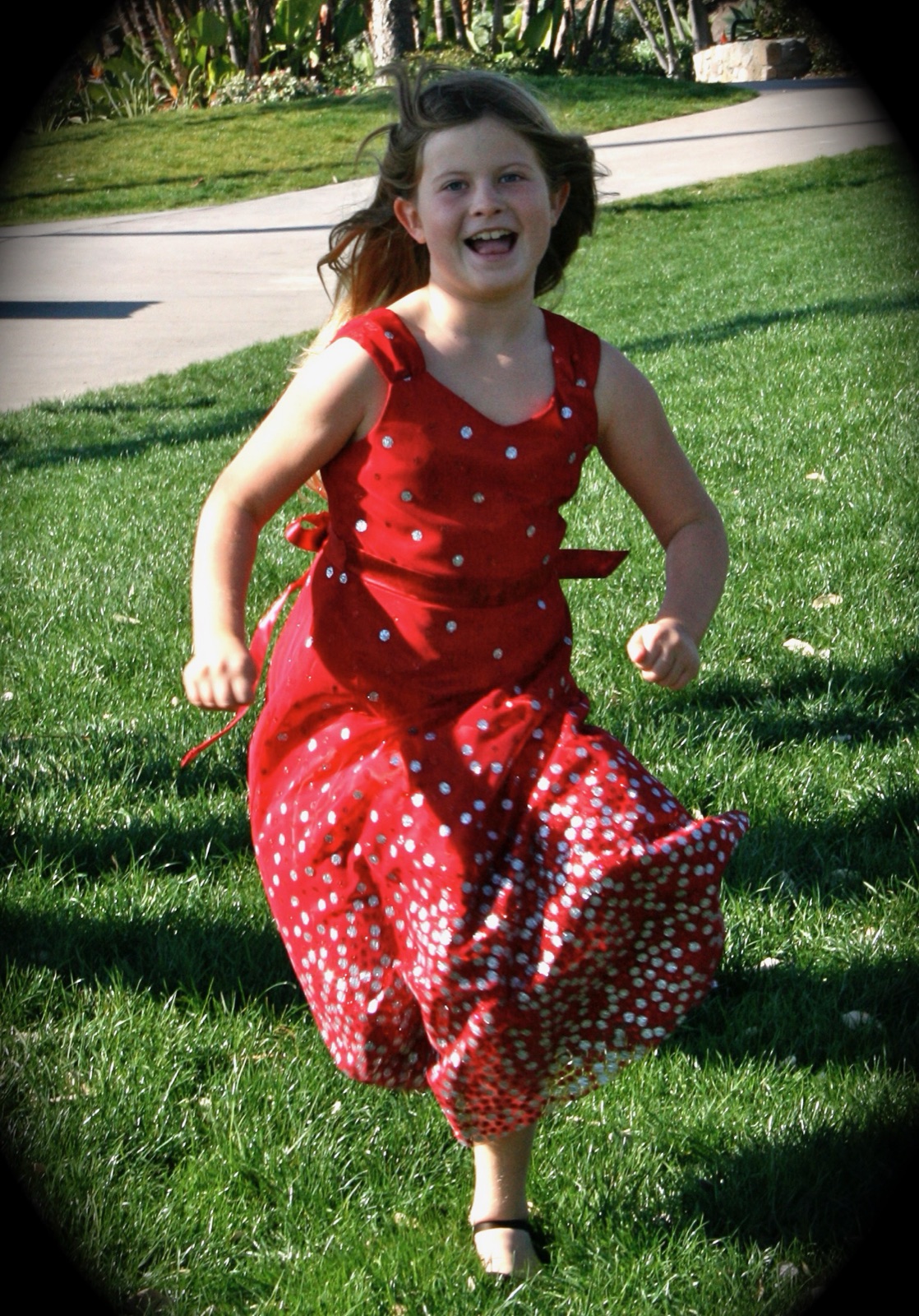 Emily as a child in a red dress