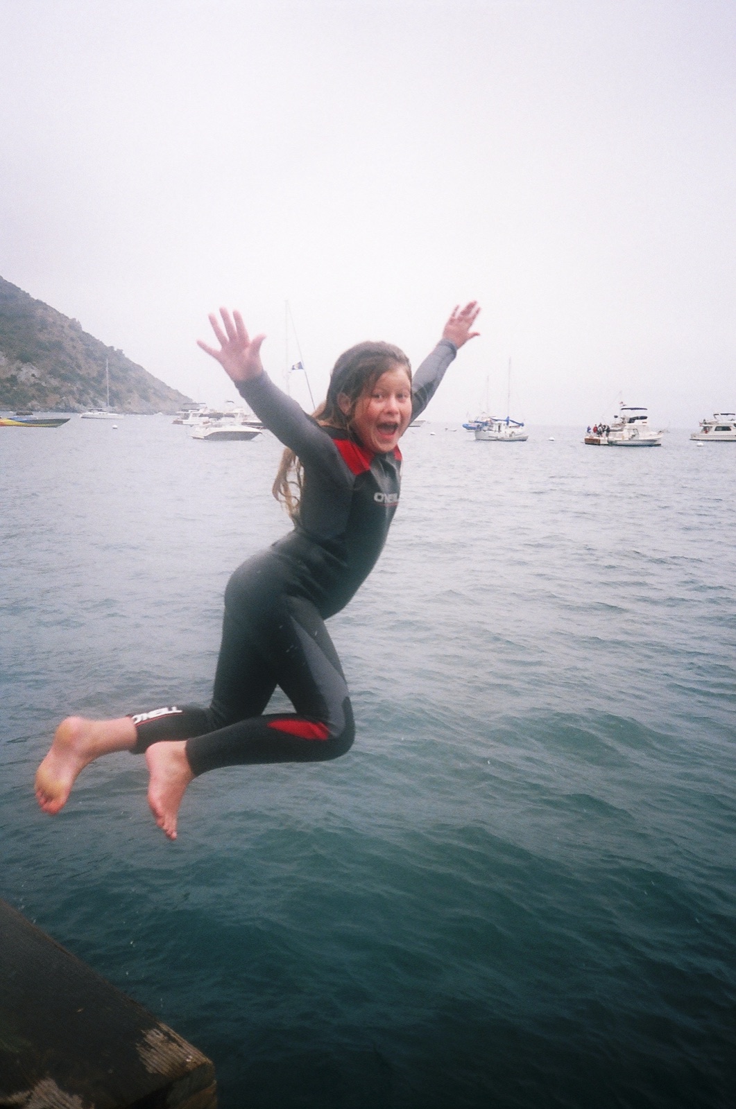 Emily as a child in a wetsuit